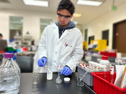 Analytical chemist preparing a personal care product for testing in a cosmetic testing laboratory. 