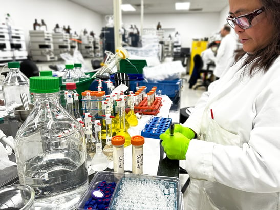 Chemist preparing samples in a laboratory for dietary supplement testing.  