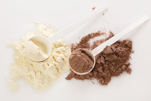 Protein powders and scoops on table