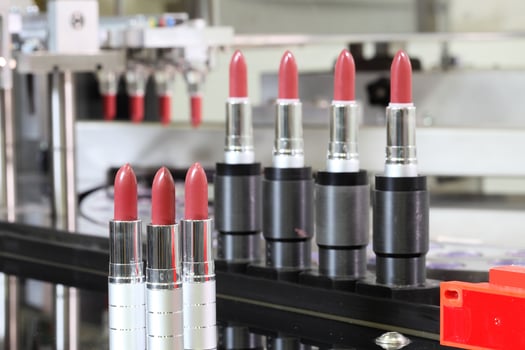 Lipstick tubes on assembly line in a cosmetic factory. 