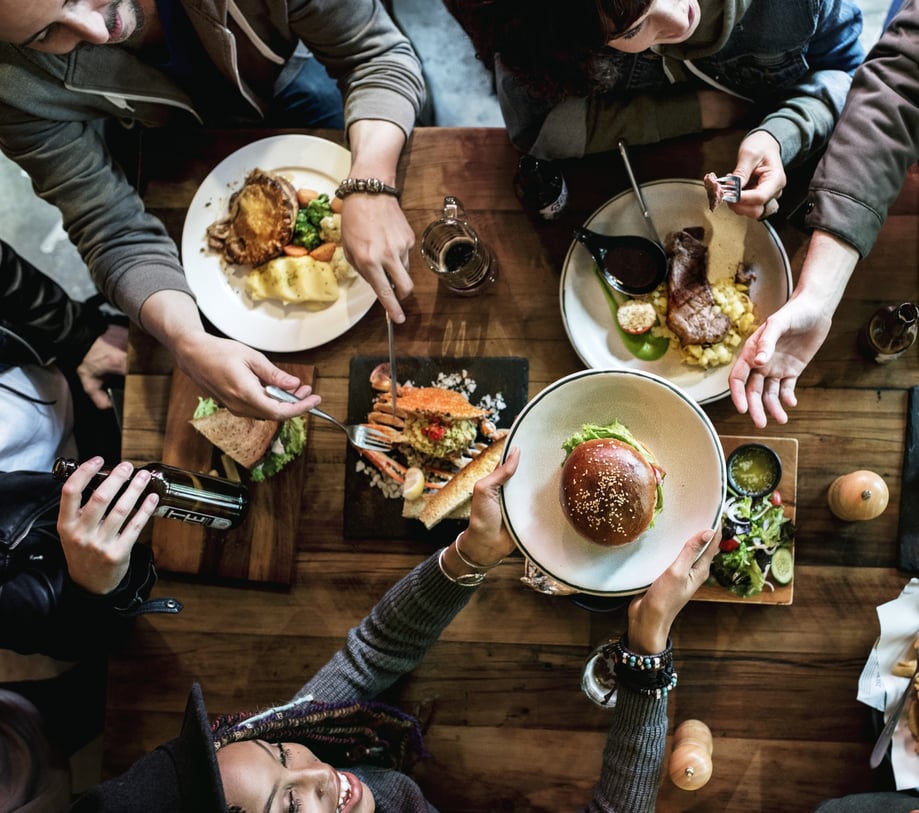 People eating together around a table.