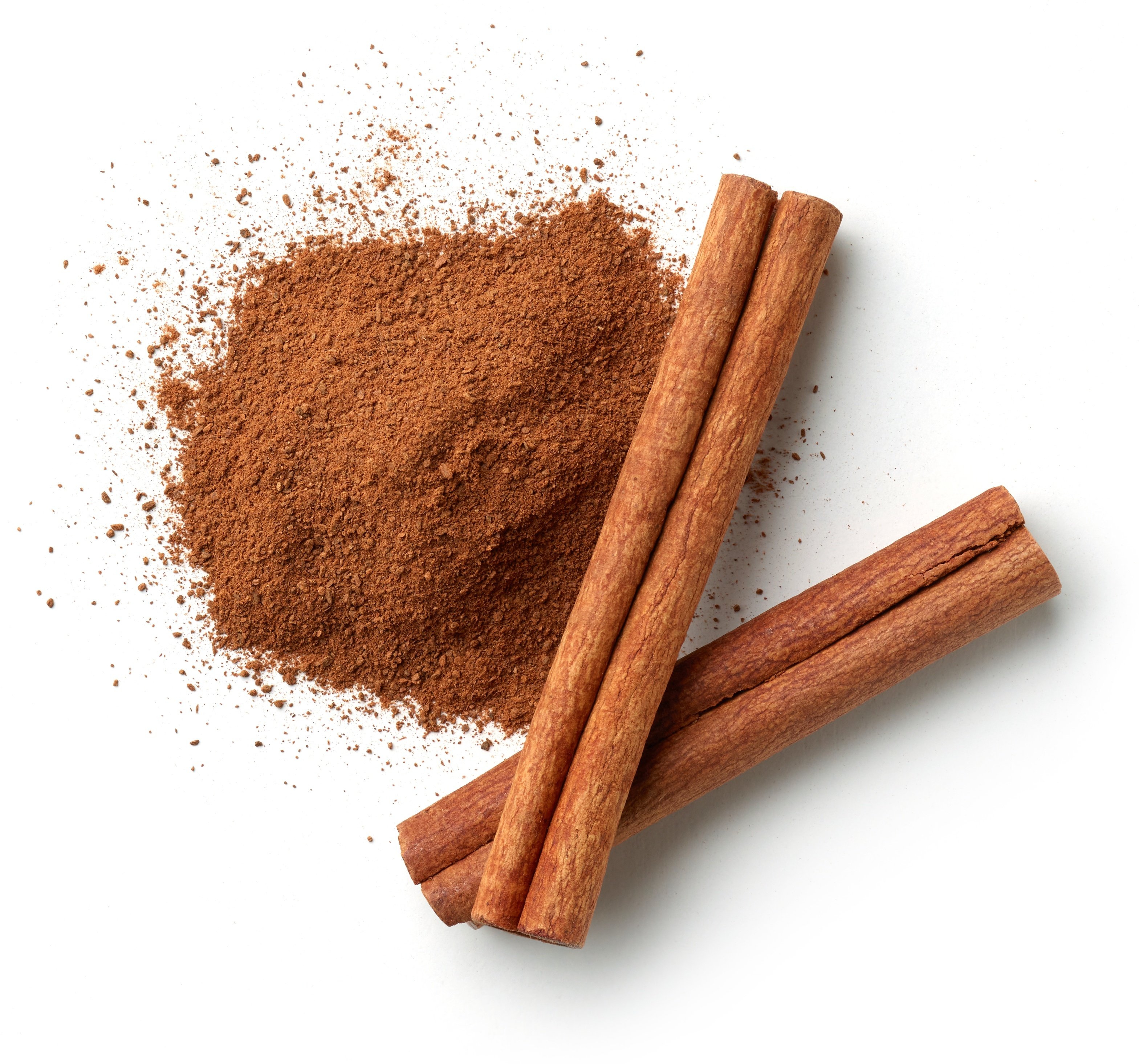 Pile of cinnamon and cinnamon sticks. 